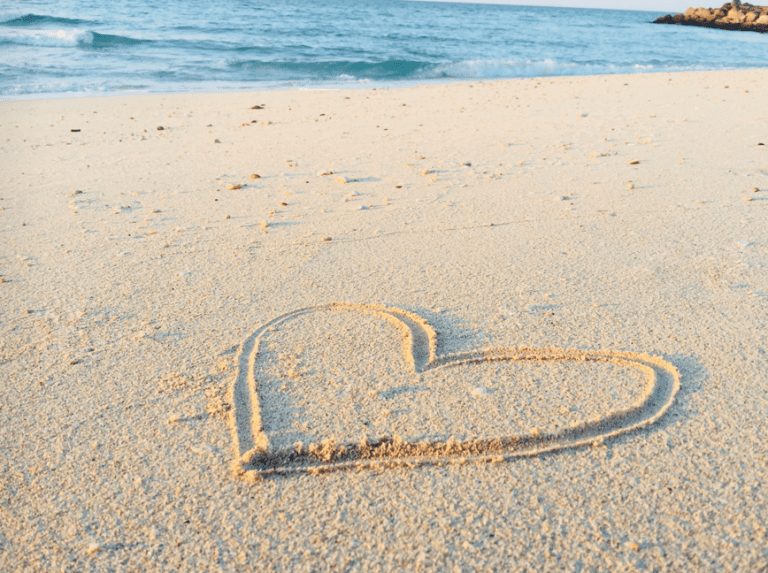 Heart drawn in sand on the beach