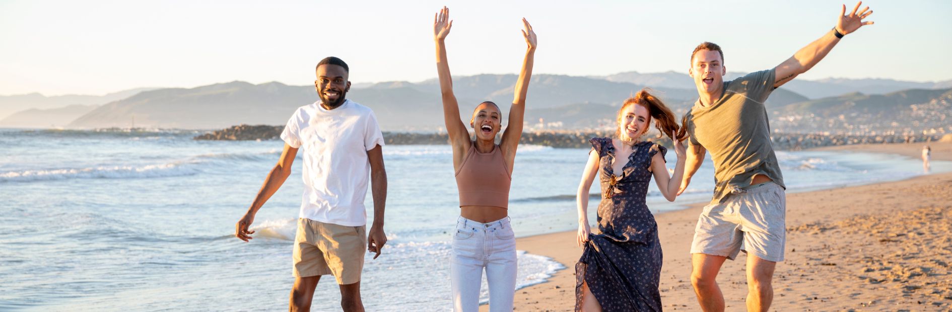 four people jumping for joy