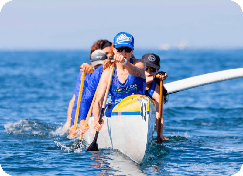 Hokuloa Outrigger Challenge participants paddling in the ocean at Ventura Harbor Village.