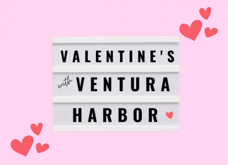 Lightbox sign reading Valentines with Ventura Harbor against a pink background with red heart graphics.