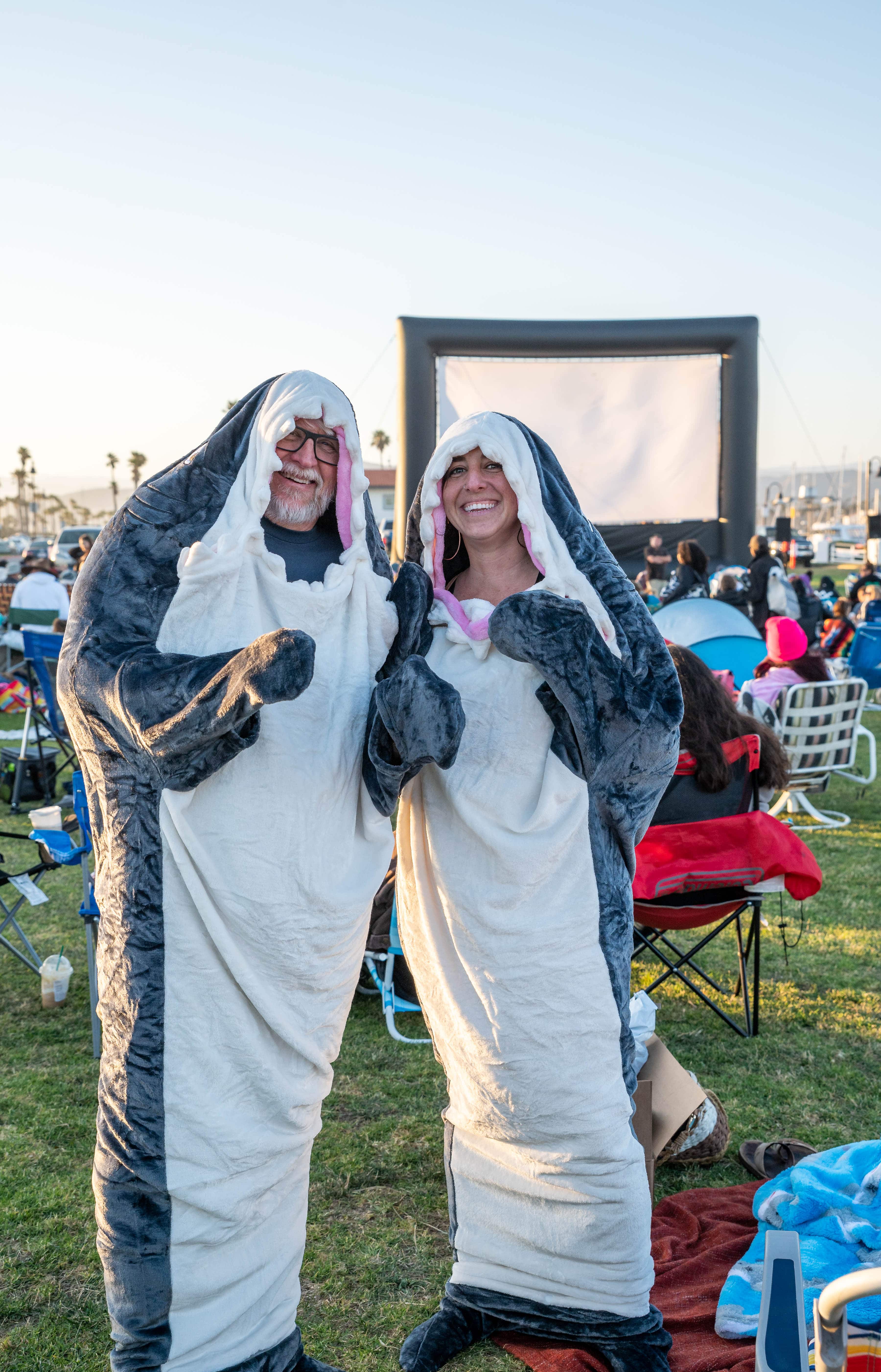 a family in shark costumes at ventura harbors seaside movie night