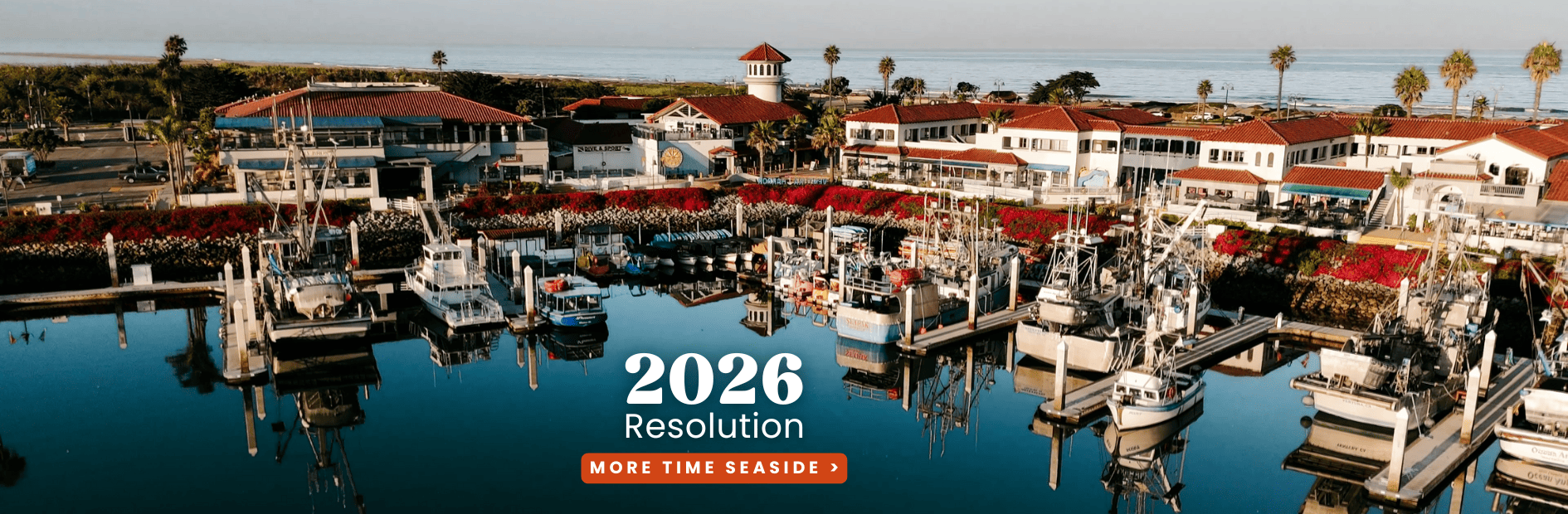 Panoramic view of Ventura Harbor Village with boats and waterfront shops in 2023.