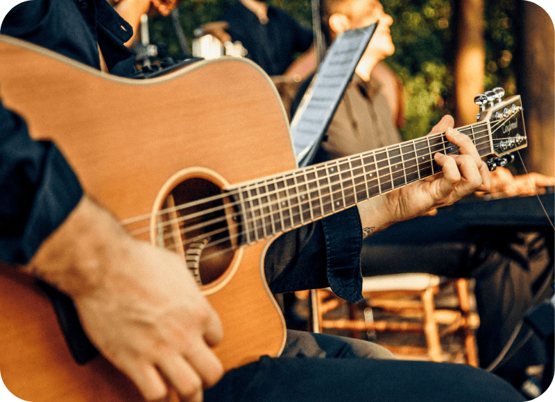 Live music performance at Ventura Harbor Village with guitar and audience.