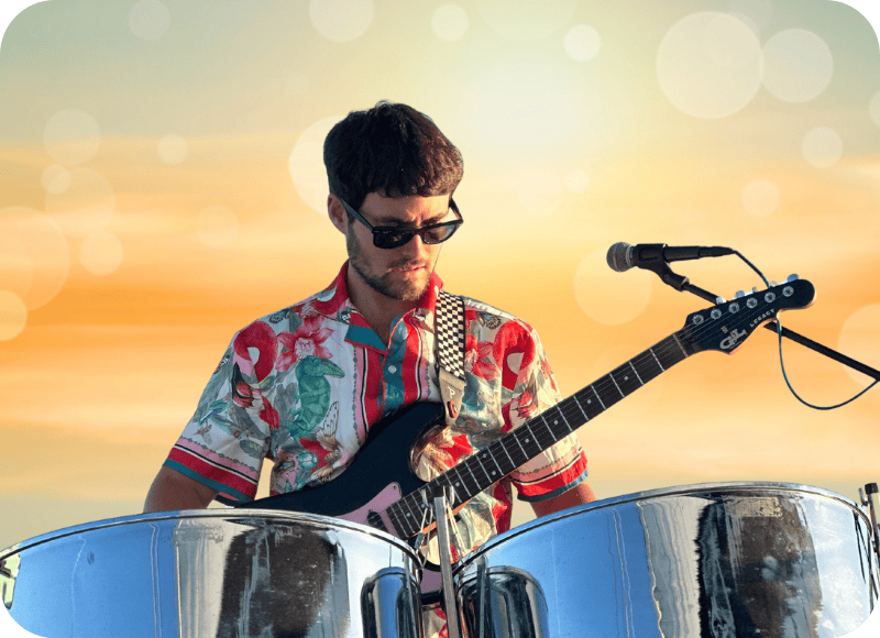 Musician playing steel drums at Ventura Harbor Village during sunset.
