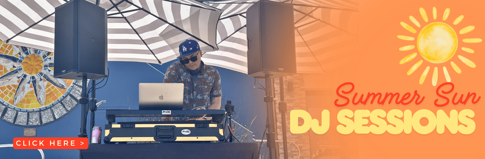 DJ performing at Ventura Harbor Village summer sun event with speakers and umbrella.