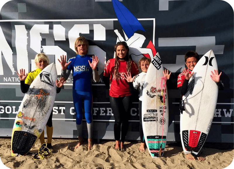 Young surfers with surfboards at Ventura Harbor Village during NSSA Surf Competition.