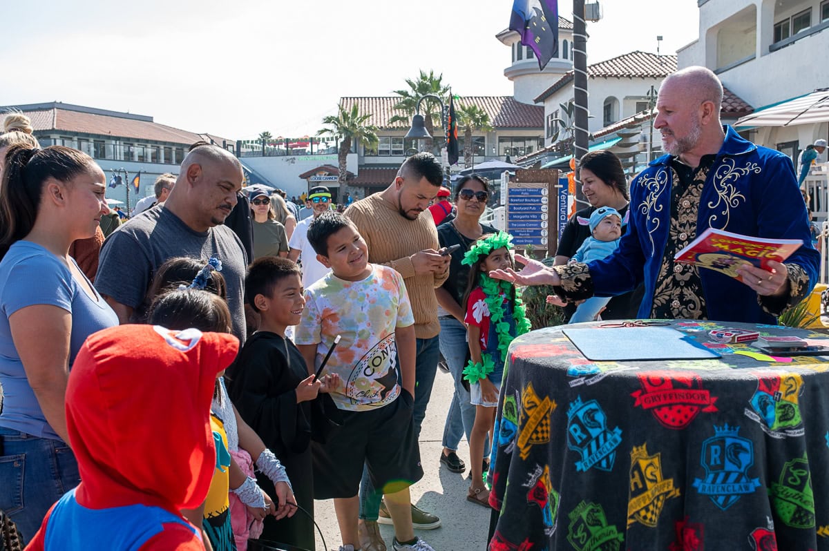Magician performing at Ventura Harbor Village during Seaside Trick or Treat 2026 event.