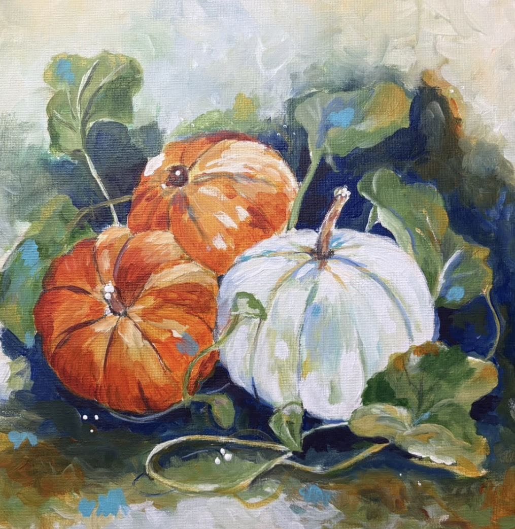 Painted pumpkins in autumn colors with green leaves and vines.